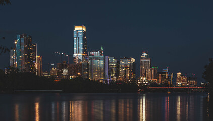 Fototapeta na wymiar Austin Downtown lights up across Colorado River