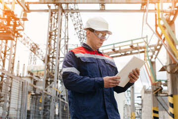 The energy engineer inspects the equipment of the substation. Power engineering. Industry