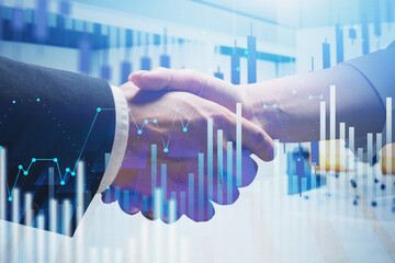 Man and woman shaking hands, financial graphs