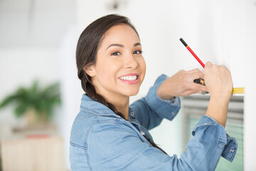 smiling woman measuring up for diy