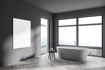 Fototapeta na wymiar Stylish gray bathroom corner with tub, poster and windows