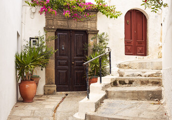 Fototapeta na wymiar vintage wooden door on the old street of the village of Lindos, Greece 