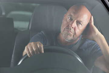 bored car driver waiting in a traffic jam - obrazy, fototapety, plakaty