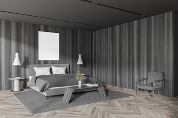 Dark wooden master bathroom corner with armchair and poster