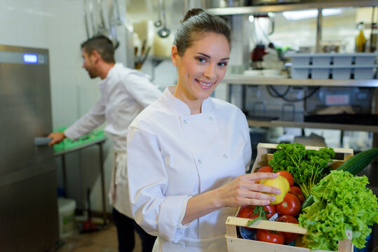 smiling happy female chef woman holds basket vegetable