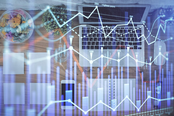 Stock market graph and top view computer on the table background. Multi exposure. Concept of financial education.