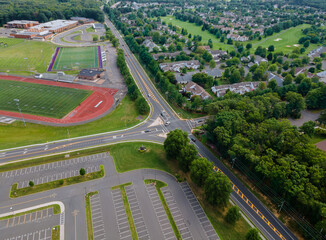 Aerial view of empty stadium with basketball field and training ground along athletic stadium running track in school a during a pandemic