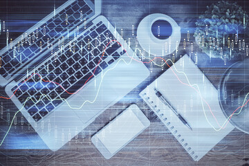 Financial market graph and top view computer on the desktop background. Double exposure. Investment concept.