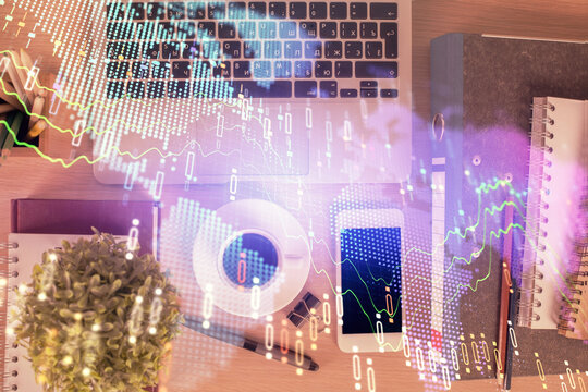 Double exposure of financial graph hologram over desktop with phone. Top view. Mobile trade platform concept. - Powered by Adobe