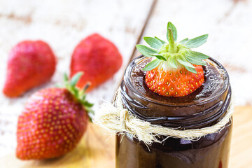 typical Brazilian strawberry jam with fruits, on rustic white wooden background. Healthy breakfast with fresh fruits