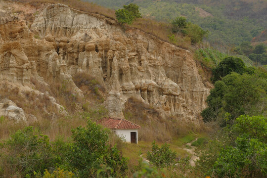Small house at the foot of the hill in the Unique Natural Area Los Estoraques, full of trees