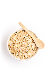 Oat flakes on a bowl and a wooden spoon
