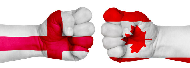 Two hands are clenched into fists and are located opposite each other. Hands painted in the colors of the flags of the countries. Canada vs England