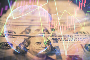 Double exposure of forex graph drawing over us dollars bill background. Concept of financial markets.