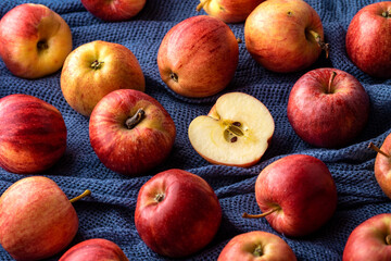 Red apples on a dark blue fabric background