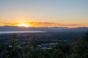 Beautiful sunset above a city sitting around a lake