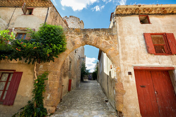Fototapeta na wymiar Arched street in the medieval village of Villerouge-Termenes, South of France