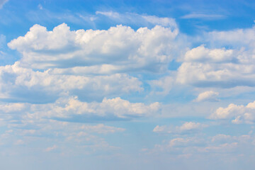 Idyllic cloudscape sky with white cumulus clouds. Crassic sky background, light fluffy white clouds