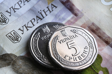 Ukrainian hryvnia coins placed on 100 UAH bills. New type of coins released in 2019 substitute...