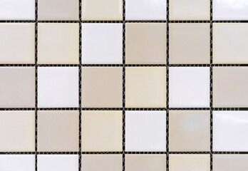 Ceramic mosaic tiles with yellow, beige and white squares.