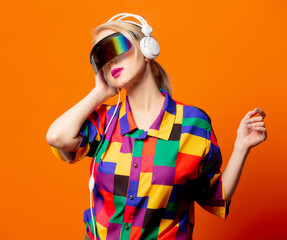 Style blonde in 90s clothes with VR glasses and headphones