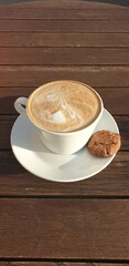 Cup of cappuccino on a wooden table