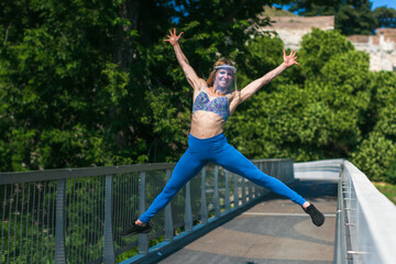young woman wearing a protective visor and jumping outdoors