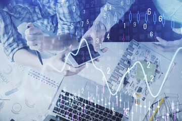 Double exposure of forex graph drawing and man and woman working together holding and using a mobile device. Trade concept.