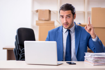 Young male employee in relocation concept