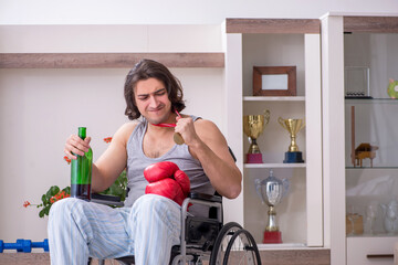 Male ex-champion boxer in wheel-chair suffering from alcoholism