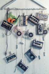 Several antique cassette tape and orange headphones