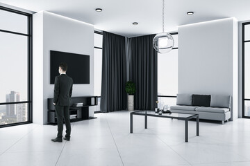 Businessman standing in modern living room