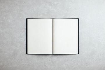 Abstract open white book standing on concrete table.