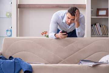 Young male employee working from the house