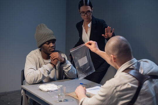 An experienced investigator during the interrogation shows the alleged criminal and his lawyer evidence of the crime committed.