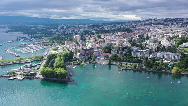 View from drone of lake Leman and houses of swiss city Lausanne in cloudy summer day