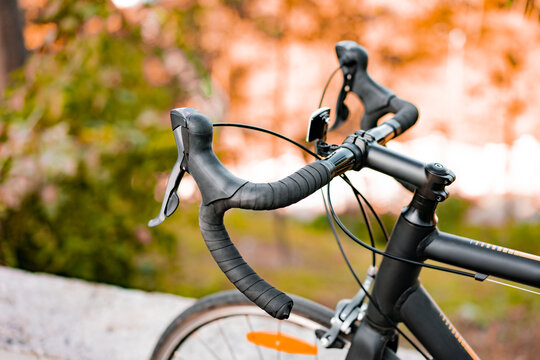 Dropbar handlebar, speed shifter and brakes of road bike on a blurred background of nature. Transport. Transportation. Sport
