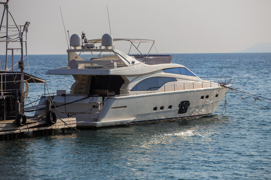 motor yacht moored at a pier on the sea