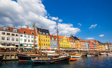 Fototapeta premium Copenhagen, Denmark-2 August, 2019: Famous Nyhavn (New Harbour) bay in Copenhagen, a historic European waterfront with colorful buildings. A starting point for boat and canal tours