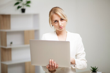 Young woman working at lap top in the office.