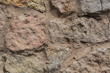 Old brick wall of rough stone