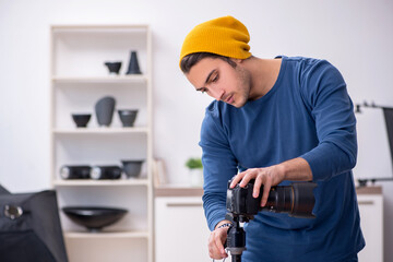 Young male photographer working in the studio