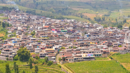 Fototapeta premium view a thin fog covers the village of Kruwisan on the slopes of Mount Sumbing, Temanggung, Central Java, Indonesia