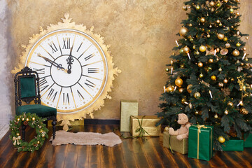 Christmas eve decoration with vintage clock. Time to New Year, interior with fer-tree, big clock, toys and soft armchair. Green & brown colors in wooden room.  Comfort home. Christmas presents