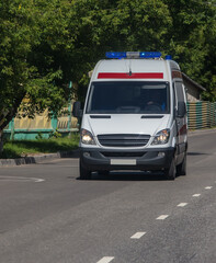 Fototapeta na wymiar Ambulance car moves along street