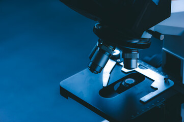 Laboratory equipment optical microscope, closeup of scientific microscope with metal lens, data...