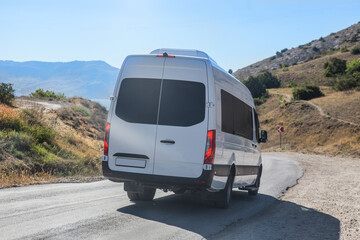 Minibus Moves along the Mountain Winding Road to the Sea