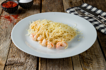 Pasta spaghetti with shrimps on old wooden table
