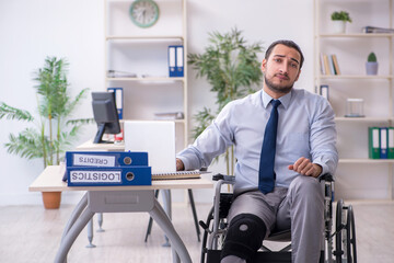 Young leg injured employee working in the office