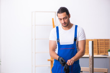 Young male contractor working in workshop